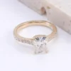 Product photograph showing a rectangular solitaire ring.