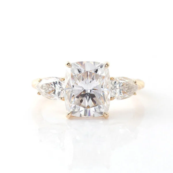 Product photograph showing the cushion three-stone ring.