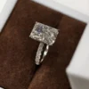 Product photograph showing a rectangular solitaire ring.