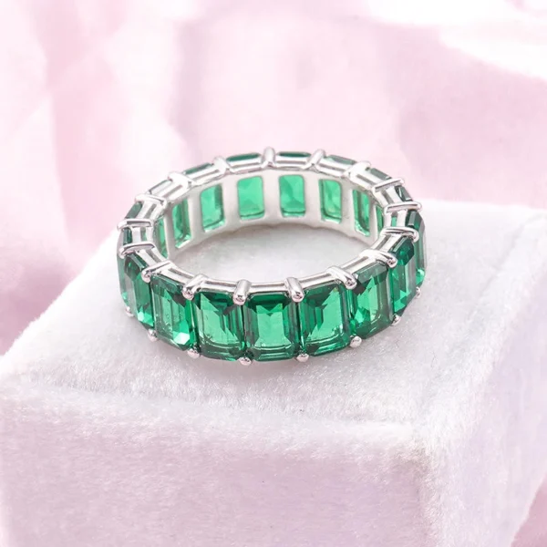 Product photograph showing the emerald eternity ring.