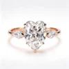 Product photograph showing the heart three-stone ring.