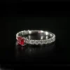 Product photograph showing the emerald solitaire ring.