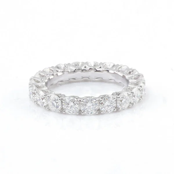 Round Moissanite Eternity Ring in 925 Sterling Silver shown in the product photograph.