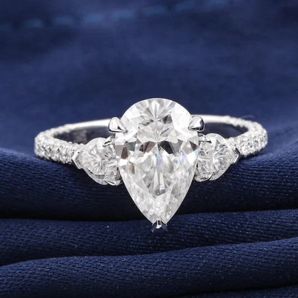 Product photograph showing the pear three-stone ring.